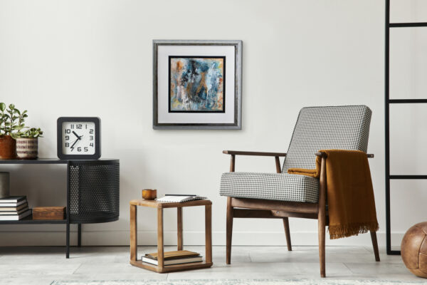 Modern Scandinavian living room with minimalist armchair, black wall art, wood accents, and cozy decor.